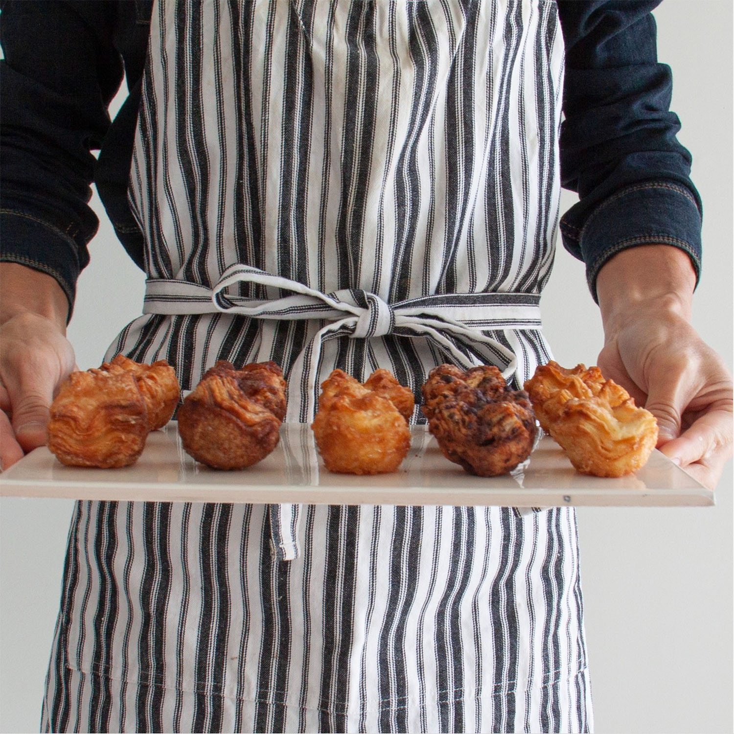 chef with homemade tray of kouign amann